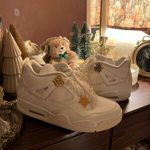 Gold and white Jordan 4s